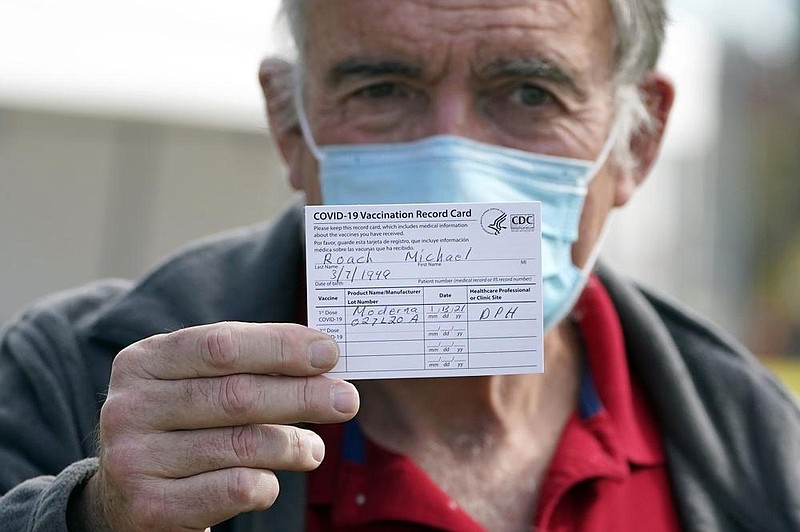 Dr. Michael Roach, a specialist in internal medicine and geriatrics, shows his vaccination card Wednesday at a site for health care workers at Ritchie Valens Recreation Center in Pacoima, Calif. More photos at arkansasonline.com/114vaccine/.
(AP/Marcio Jose Sanchez)