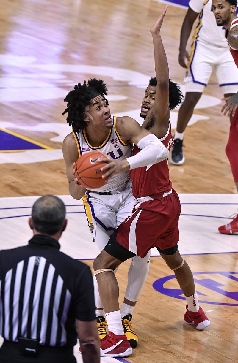 LSU forward Trendon Watford (left) tries to move past Arkansas guard Moses Moody during the Tigers’ victory over the Razorbacks on Wednesday in Baton Rouge. Watford had 23 points on 9-of-16 shooting with 10 rebounds.
(AP/The Advocate/Hilary Scheinuk)