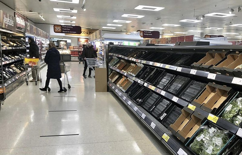 Shelves in a Sainsbury’s supermarket in Belfast are depleted Monday. Brexit rules are disrupting food supplies, businesses warn.
(David Young/PA via AP)