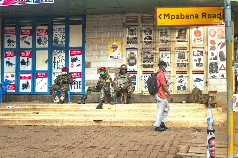 Ugandan security forces patrol the streets Wednesday near opposition leader Bobi Wine’s headquarters in Kampala.
(AP/Jerome Delay)