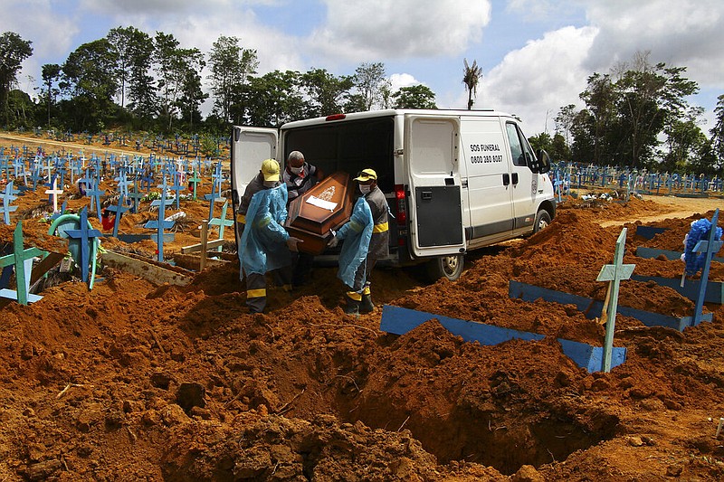 FILE - In this Jan. 6, 2021, file photo, cemetery workers carry the remains of 89-year-old Abilio Ribeiro, who died of the coronavirus, to bury at the Nossa Senhora Aparecida cemetery in Manaus, Amazonas state, Brazil.