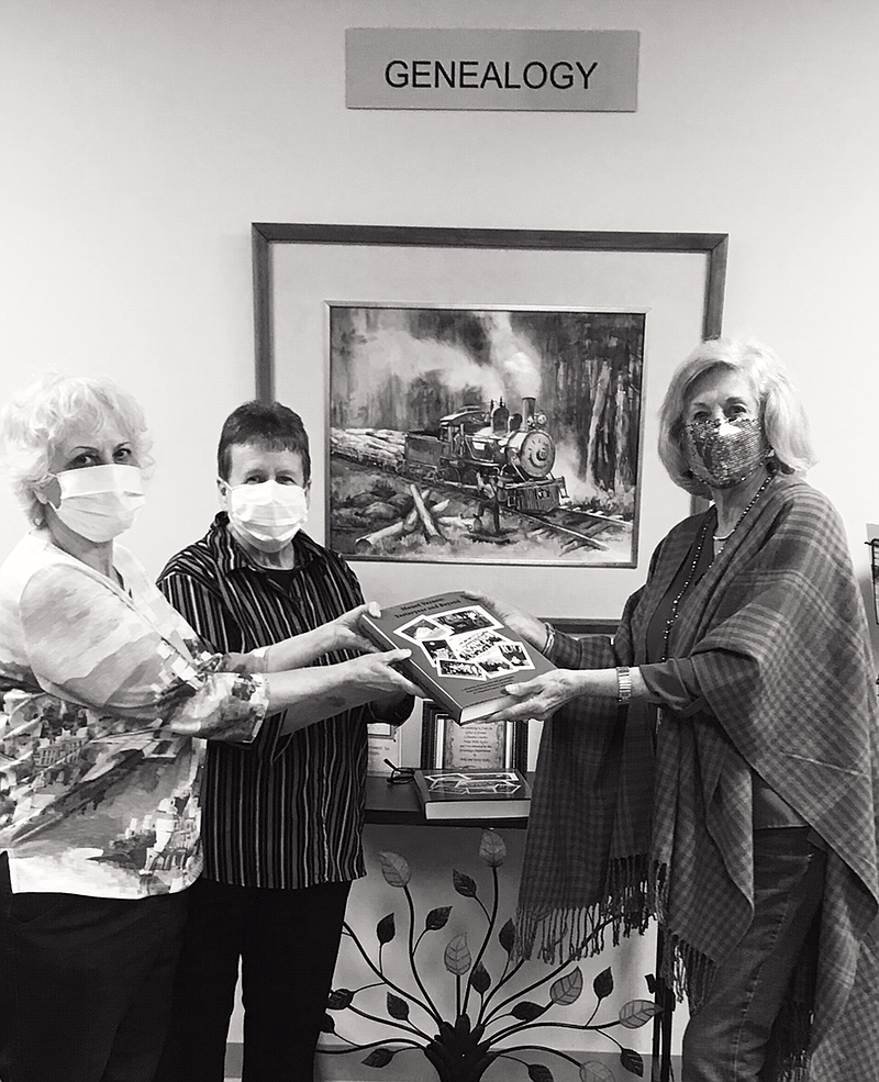 Jane Renfro Hammond (far right) presents a copy of her book, Mount Vernon: Yesteryear and Beyond to Rhonda Rolen (far left) and Susan Walker of the Columbia County Library.