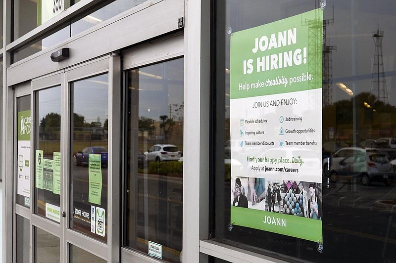 A sign advertises job openings Tuesday at a Joann fabric and craft store in Orlando, Fla. The number of people seeking unemployment aid rose last week by the most since late August.
(AP/John Raoux)
