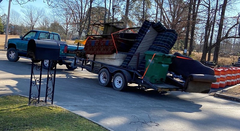 A truck and trailer are filled with debris and other furniture picked up Saturday morning, Jan. 16, 2021, as part of the cleanup in Pine Bluff.