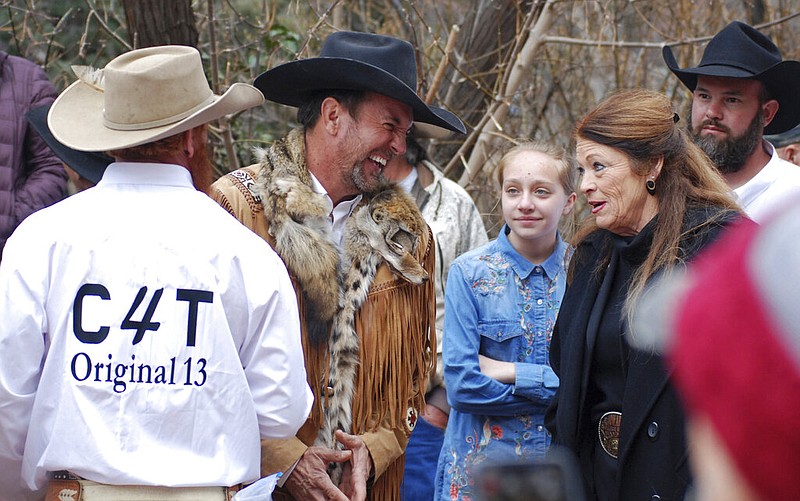 Couy Griffin (center), the leader of Cowboys for Trump and an Otero County, N.M., commissioner, talks with New Mexico state Rep. Candy Ezzell, R-Roswell, N.M., at a protest against gun control and pro-abortion rights legislation outside the New Mexico state Capitol in Santa Fe in this March 12, 2019, file photo. Griffin has been arrested on charges of illegally entering the U.S. Capitol during the Jan. 6, 2021, riot there.