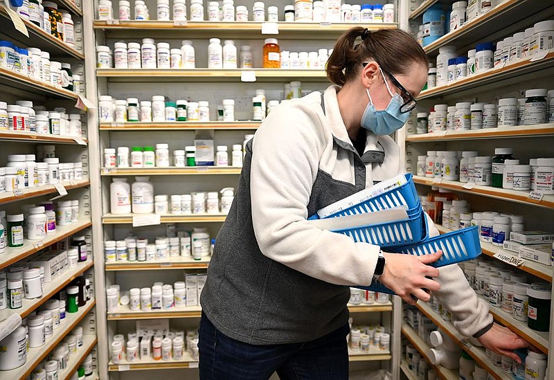 Holley Maness fills prescriptions Friday at Market Place Pharmacy in Little Rock. A pharmacy manager said Market Place and sister location City Pharmacy have nearly 5,000 people on the waiting list for the coronavirus vaccine.
(Arkansas Democrat-Gazette/Stephen Swofford)