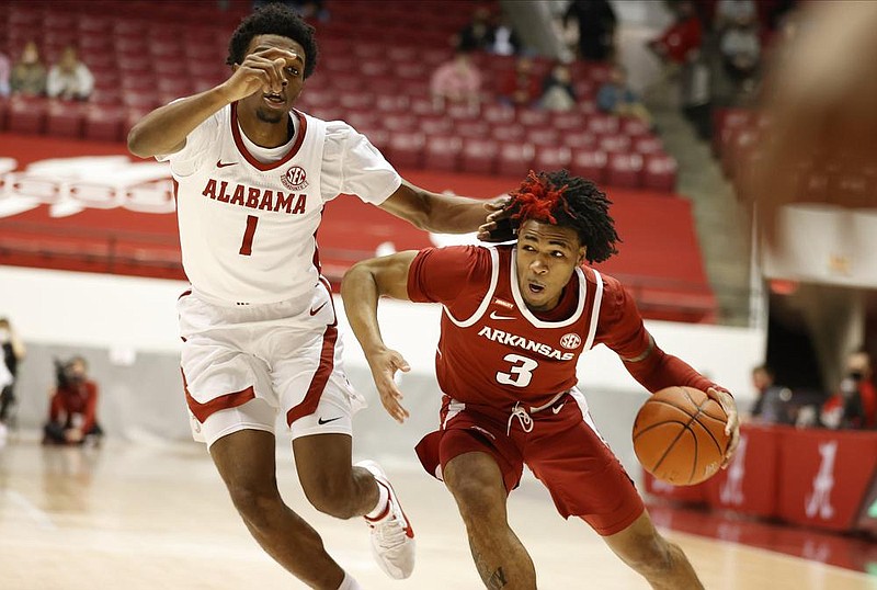 Arkansas’ Desi Sills attempts to drive toward the basket while being pressured by Alabama’s Herbert Jones during the Razorbacks’ loss to the Crimson Tide on Saturday at Tuscaloosa, Ala. Arkansas has lost four of its past five games.
(Photo courtesy of the SEC)