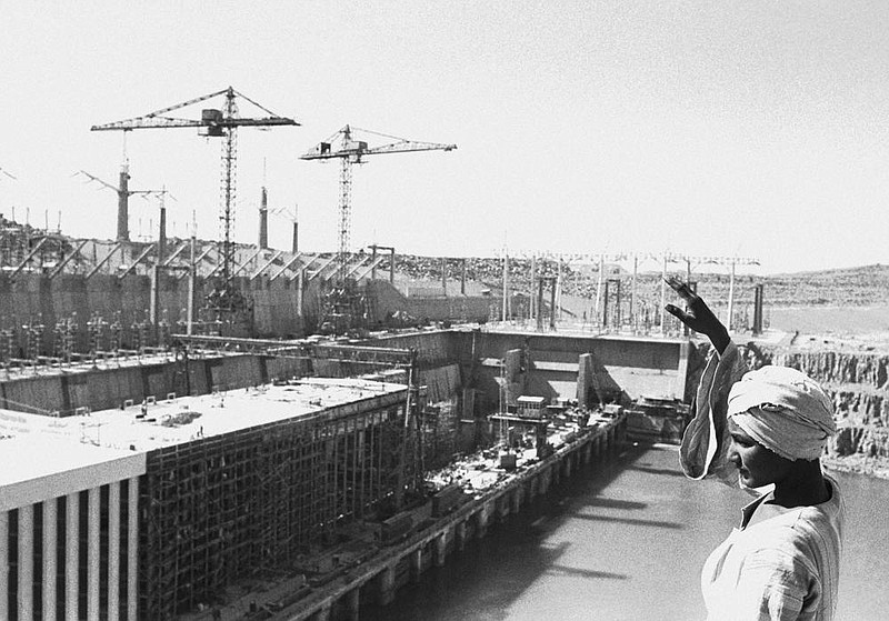 A worker waves from atop a rock in 1968 overlooking the partly constructed power station on the Aswan High Dam in Egypt. Egyptians are marking 50 years since the inauguration of the Nile dam.
(AP file photo)
