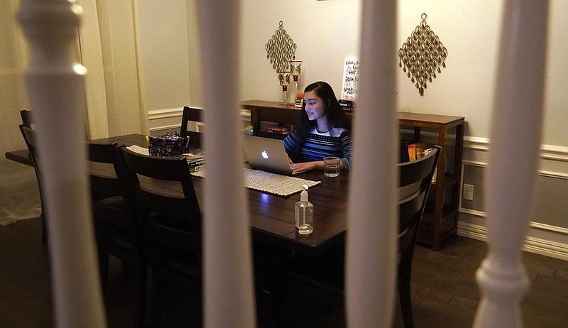 Charvi Goyal, 17, gives an online math tutoring session from her family’s home in Plano, Texas.
(AP/LM Otero)