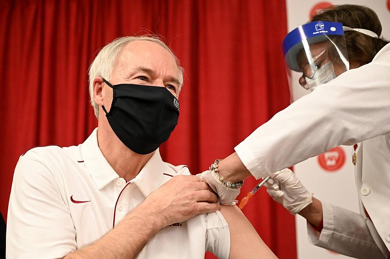 Governor Asa Hutchinson receives his first dose of the COVID-19 vaccine at the Department of Health in Little Rock on Monday, Jan. 18, 2021. (Arkansas Democrat-Gazette/Stephen Swofford)