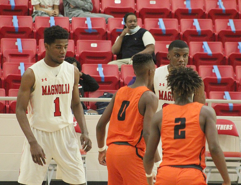 Magnolia juniors Devonte Walker (1) and Derrian Ford (20) prepare for an inbound play against two Warren Lumberjacks. 