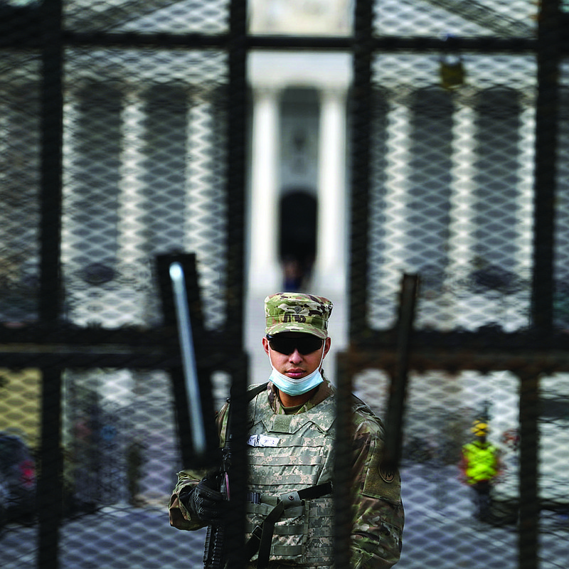 Members of the National Guard stand inside the security fencing at the Capitol ahead of the inauguration of President-elect Joe Biden and Vice President-elect Kamala Harris, Sunday, Jan. 17, 2021 in Washington. (AP Photo/John Minchillo)