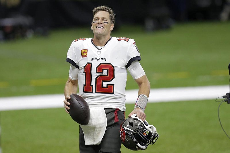 Tampa Bay Buccaneers quarterback Tom Brady smiles after an NFL divisional round playoff football game against the New Orleans Saints, Sunday, Jan. 17, 2021, in New Orleans. The Tampa Bay Buccaneers won 30-20. (AP Photo/Brett Duke)