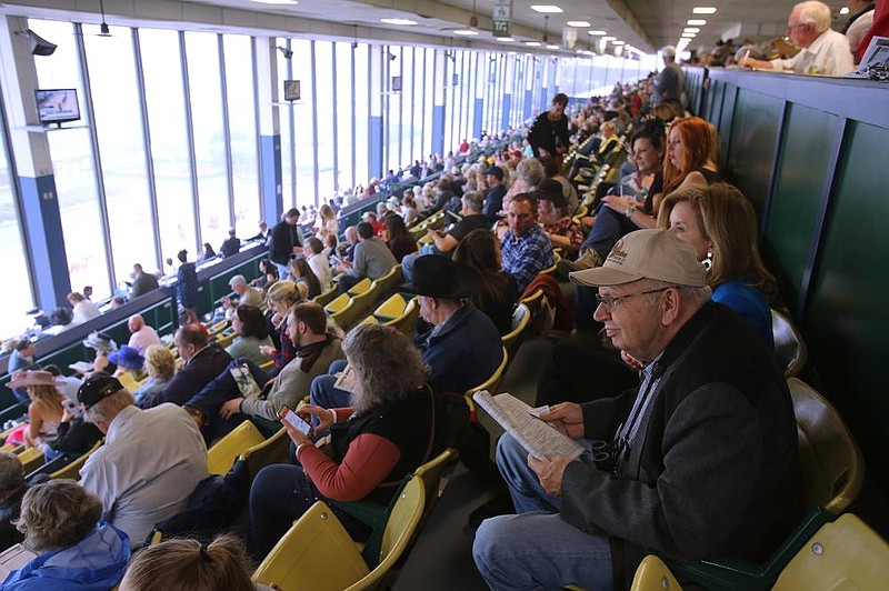 Race fans watch as horses take the track before a 2019 race at Oaklawn in Hot Springs. Fans were prohibited from attending live racing at Oaklawn last year because of the coronavirus pandemic, and new rules will be in place this year to accommodate a restricted number of fans while adhering to health and safety protocols established by the Arkansas Department of Health.
(Arkansas Democrat-Gazette/Thomas Metthe)