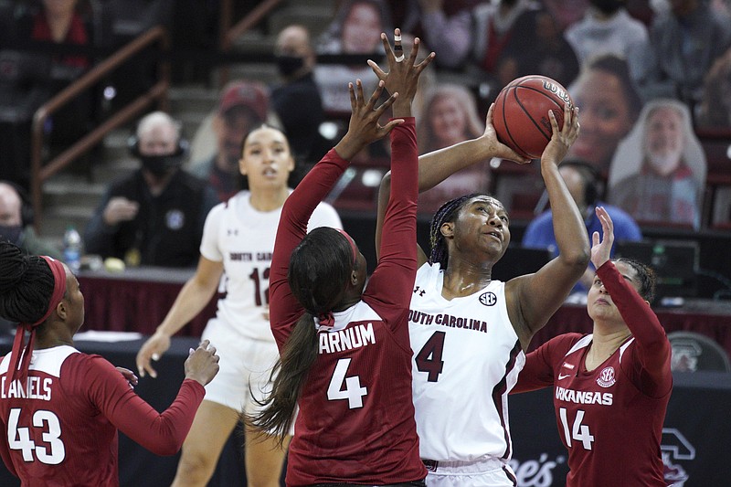 South Carolina forward Aliyah Boston (center) attempts a shot against Arkansas forward Erynn Barnum (left) and guard Jailyn Mason during the first half Monday in Columbia, S.C. Boston had 26 points, 16 rebounds and 6 blocks to lead No. 4 South Carolina to a 104-82 victory.
(AP/Sean Rayford)