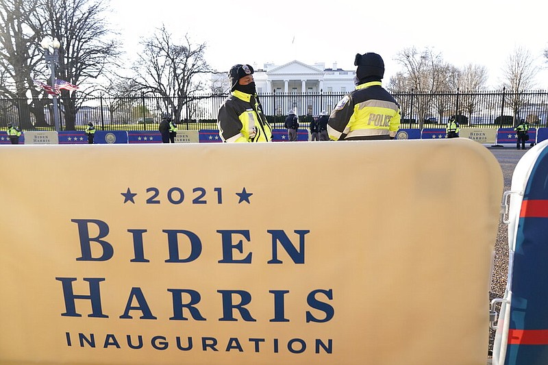 Washington Metropolitan Police stand along the escort parade route in front of the White House early Wednesday, Jan. 20, 2021.