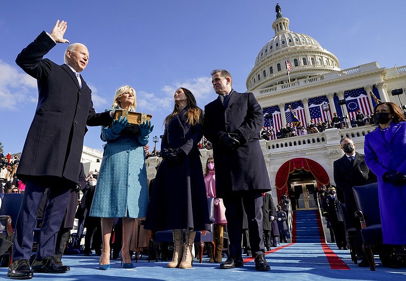 Joe Biden is sworn in as the 46th president of the United States by Chief Justice John Roberts as Jill Biden holds the Bible during the 59th Presidential Inauguration at the U.S. Capitol in Washington, Wednesday, Jan. 20, 2021, as their children Ashley and Hunter watch.