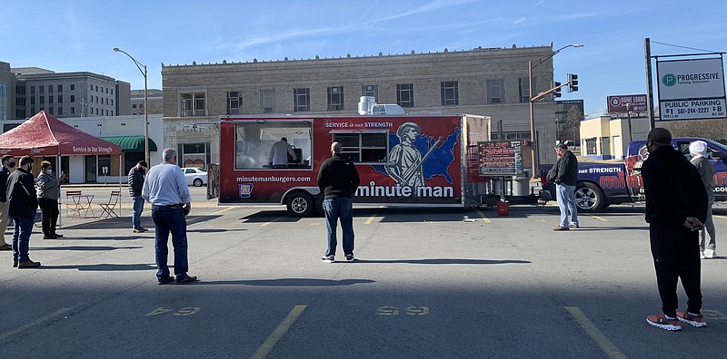 Minute Man Mobile debuted last week on a parking lot at Little Rock's West Fourth Street and Broadway, with a limited menu and a grill master smoking burgers over charcoal at the back. The truck will also be there today and Friday. (Arkansas Democrat-Gazette/Eric E. Harrison)