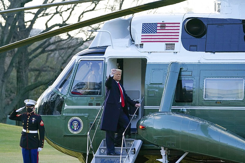 President Donald Trump gestures as he boards Marine One on the South Lawn of the White House, Wednesday, Jan. 20, 2021, in Washington. Trump is en route to his Mar-a-Lago Florida Resort.