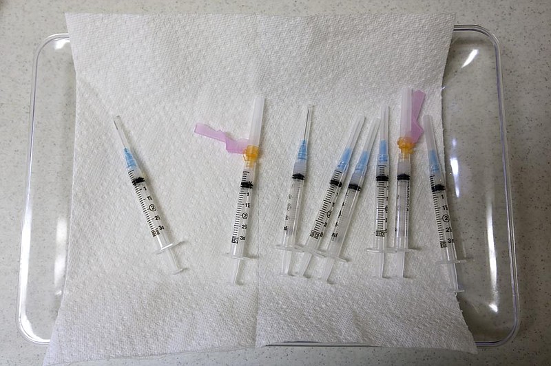 Syringes filled with the Moderna Covid-19 vaccine wait on a tray to be administered during Polk Pharmacy's drive-thru vaccine clinic on Wednesday, Jan. 20, 2021, at Landmark Baptist Church in England. 
(Arkansas Democrat-Gazette/Thomas Metthe)
