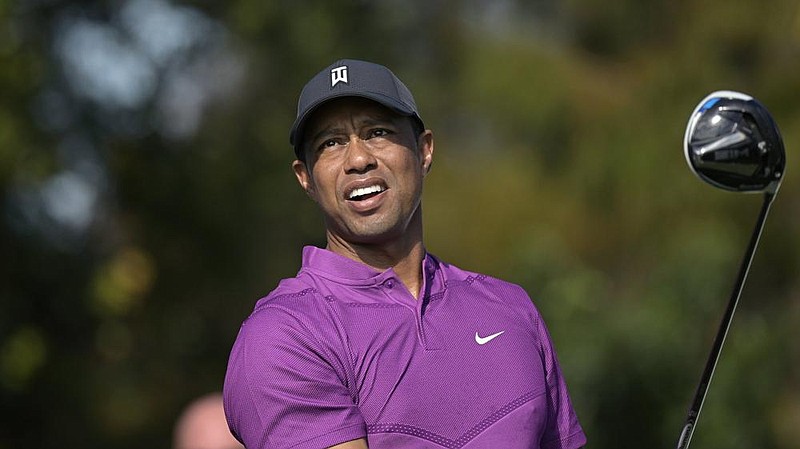 Tiger Woods watches his tee shot on the first hole during the first round of the PNC Championship golf tournament, Saturday, Dec. 19, 2020, in Orlando, Fla. (AP Photo/Phelan M. Ebenhack)