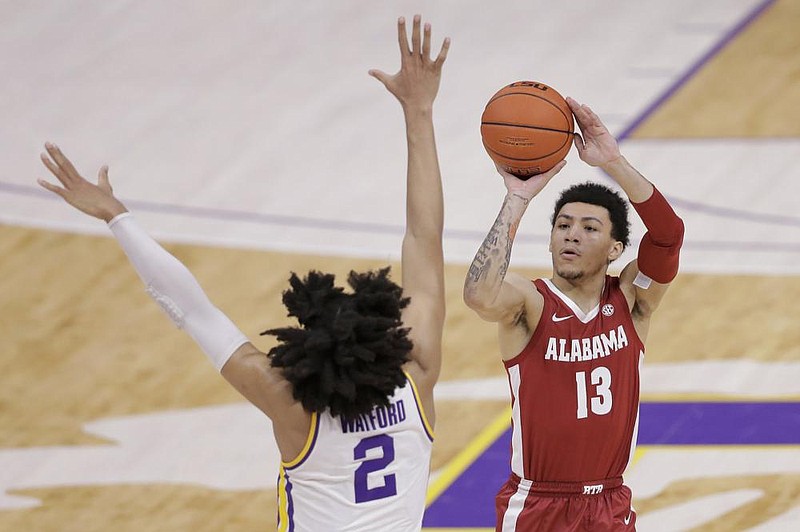 Alabama guard Jahvon Quinerly (13) shoots a 3-pointer in front of LSU forward Trendon Watford (2) in the first half of an NCAA college basketball game in Baton Rouge, La., Tuesday, Jan. 19, 2021. (AP Photo/Brett Duke)