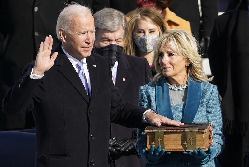 President Joe Biden takes the oath of office Wednesday from Chief Justice John Roberts on the Capitol steps as his wife, Jill, holds the Bible that has been in the Biden family for 128 years.
(AP/Andrew Harnik)