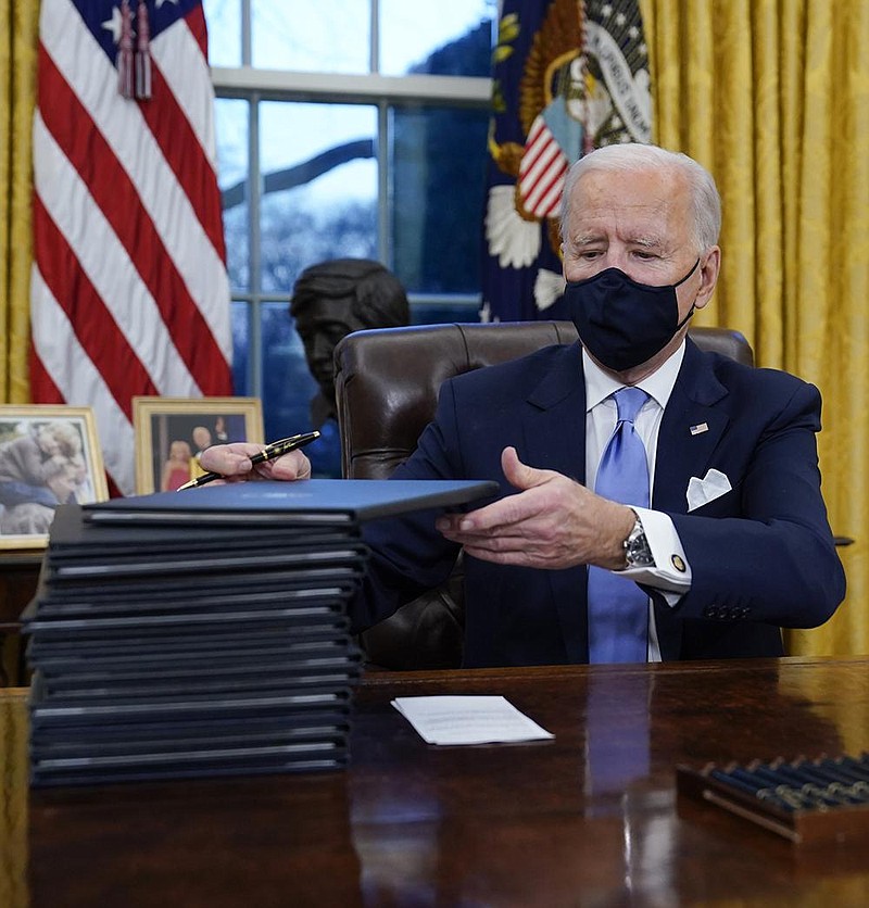 President Joe Biden signs his first executive orders Wednesday in the Oval Office of the White House. “I think some of the things we’re going to be doing are going to be bold and vital,” he said in brief remarks during the appearance. “And there’s no time to start like today.”
(AP/Evan Vucci)