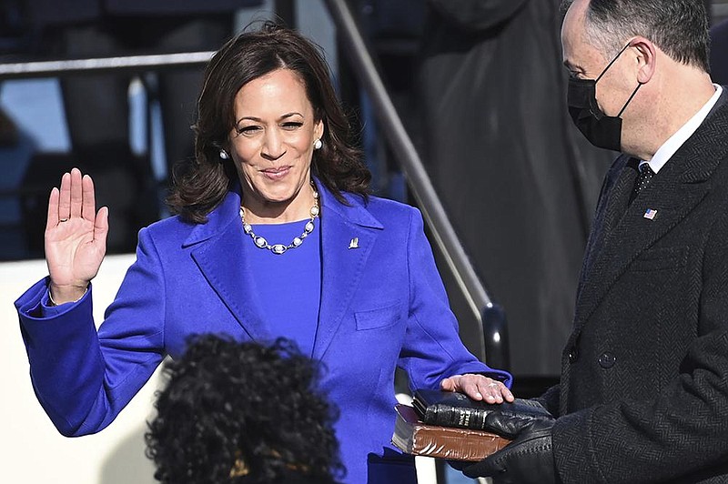 Kamala Harris breaks into a grin while being sworn in as vice president Wednesday by Supreme Court Justice Sonia Sotomayor. Harris’ husband, Doug Emhoff, holds the Bible. More photos at arkansasonline.com/121vp/.
(AP/Saul Loeb)