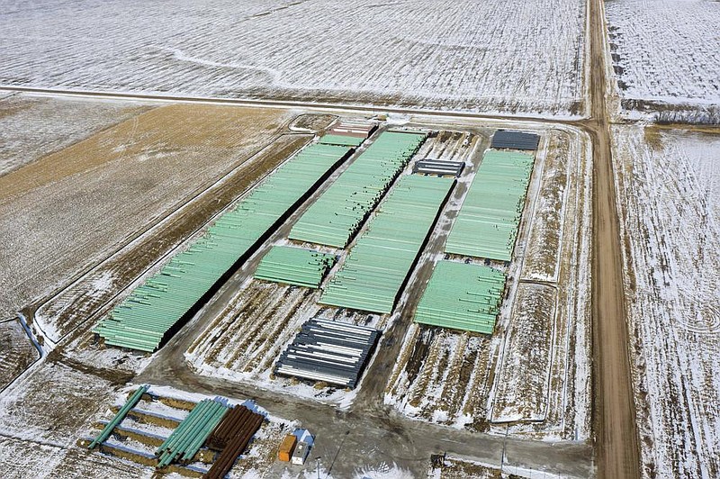 Pipe to be used for the Keystone XL oil pipeline is stored in a field near Dorchester, Neb., in December. The Canadian company behind the pipeline said Wednesday it has suspended work on the project.
(AP/Omaha World-Herald/Chris Machian)