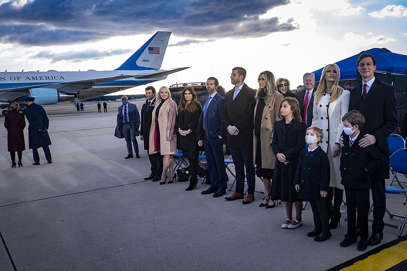 Members of Donald Trump’s family wait for him to speak to a sparse group of supporters early Wednesday before boarding Air Force One for his last time as president at Joint Base Andrews in Maryland. A 21-gun salute was part of a military send-off, complete with red carpet and color guard.
(The New York Times/Pete Marovich)