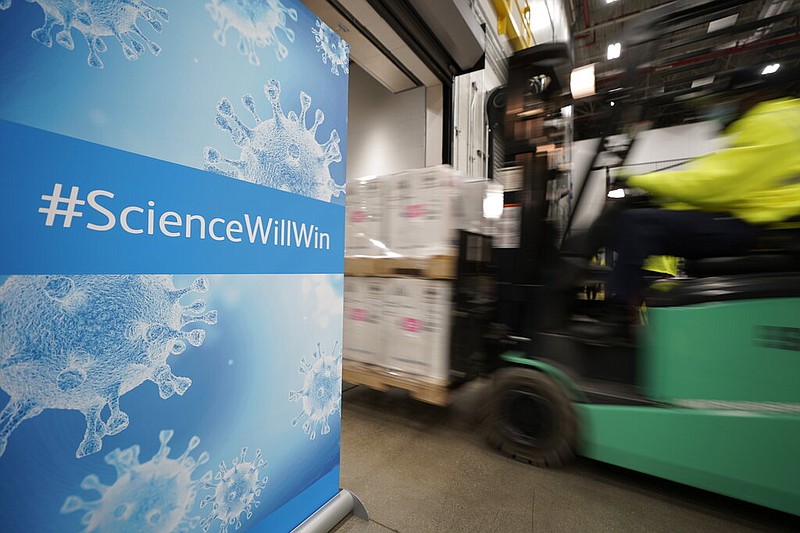 Boxes containing the Pfizer-BioNTech covid-19 vaccine are loaded onto a truck for shipping at the Pfizer Global Supply Kalamazoo manufacturing plant in Portage, Mich., in this Dec. 13, 2020, file photo.