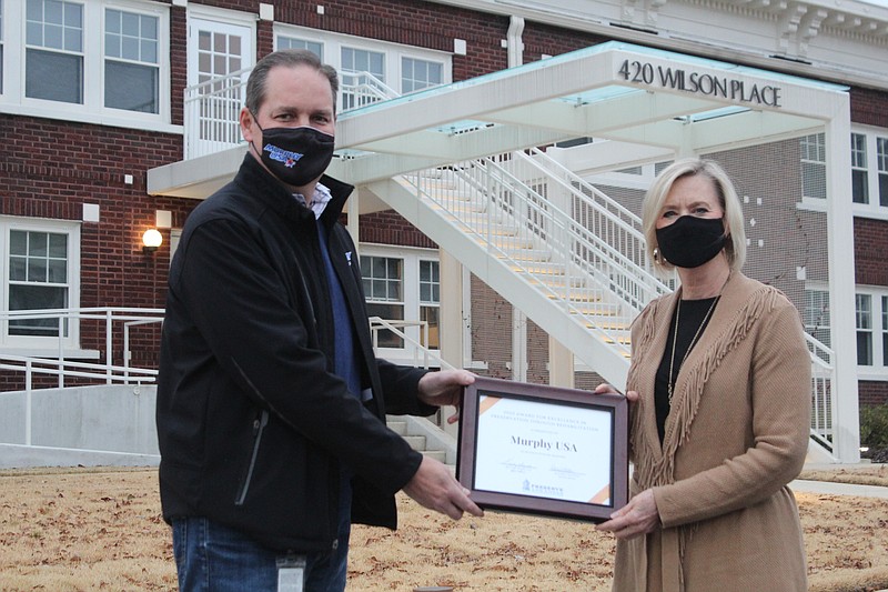 Murphy USA received the Award for Excellence in Preservation through Rehabilitation from Preserve Arkansas for restoration work done to the apartments at 421 Wilson Pl. in El Dorado. Kathy Boyette presented an award certificate to John Moore, MUSA senior vice president, on Wednesday.