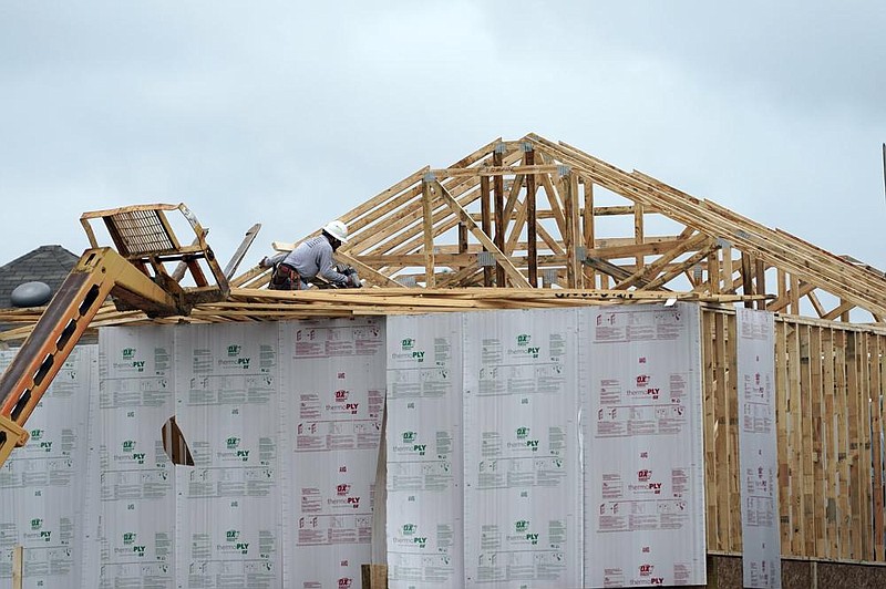 A framer works on a house in Houston in this September file photo. U.S. home construction starts rose 5.8% in December to 1.67 million units, a 14-year high.
(AP)