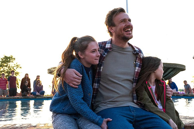 Great-hearted but troubled Dane (Jason Segel) comforts his friends’ daughters Molly (Isabella Kai) and Evie (Violet McGraw) in Gabriela Cowperthwaite’s tragic, drawn-from-life medical drama “Our Friend.”