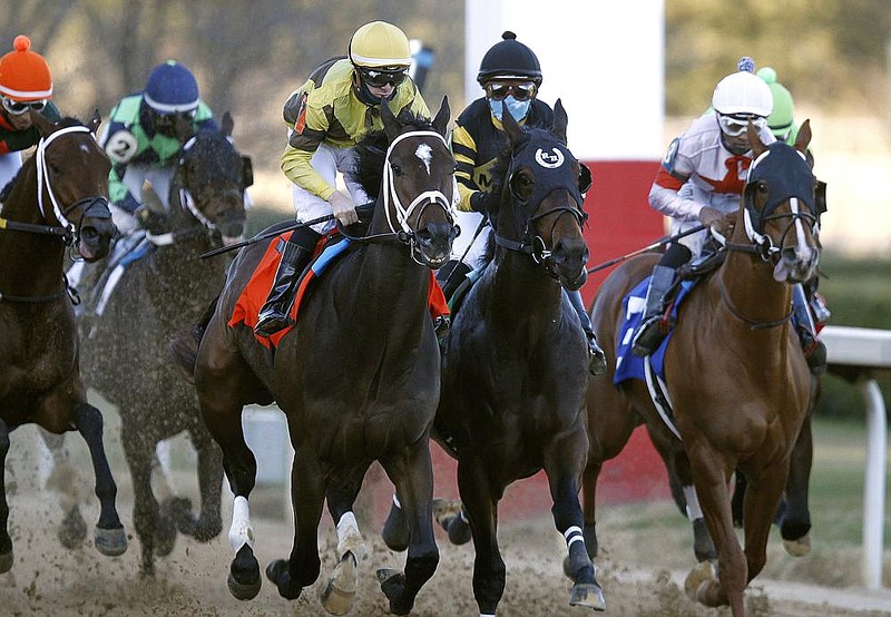 Caddo River (left) and jockey Florent Geroux take the lead en route to winning the $150,000 Smarty Jones Stakes on Friday at Oaklawn Racing Casino Resort in Hot Springs. More photos available at arkansasonline.com/123oaklawn.
(Arkansas Democrat-Gazette/Thomas Metthe)