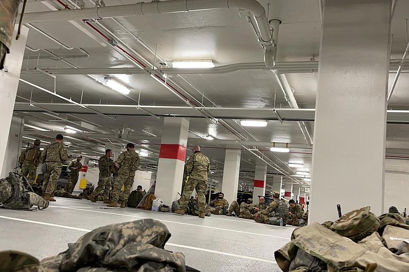 A photo provided to The New York Times shows National Guard soldiers resting Thursday in the parking garage of the Thurgood Marshall Federal Judiciary Building in Washington. National Guard troops called to D.C. to safeguard Joe Biden’s inauguration were booted out of the Capitol to rest in the unheated garage, prompting an uproar among lawmakers who scrambled to move them back. More photos at arkansasonline.com/123dcguard/.
(The New York Times)