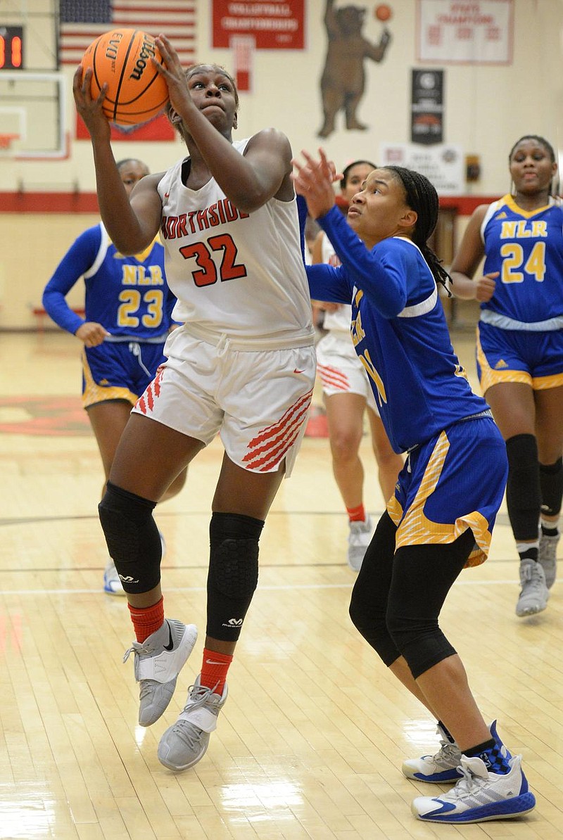 Fort Smith Northside’s Haitiana Releford (32) goes up for a shot past North Little Rock’s Arin Freeman during the first half Friday at Kaundart Grizzly Fieldhouse in Fort Smith. Releford scored six points and grabbed four rebounds during the third quarter to help Northside to a 66-53 6A-Central victory.
(NWA Democrat-Gazette/Andy Shupe)