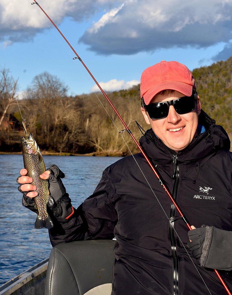 Josh Wilson of Great Falls, Va., admires one of the rainbow trout he caught Jan. 17 on the White River near Ranchette. (Arkansas Democrat-Gazette/Bryan Hendricks) 