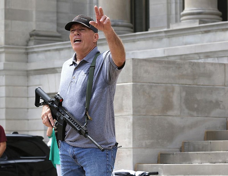 Robert "Bigo" Barnett talks to the crowd after an announcement by Rep. Dan Sullivan of a lawsuit aimed to overturn Gov. Asa Hutchinson's months-long state of emergency as well as his administration's public health directives, during a rally at the steps of the state Capitol on Thursday, Sept. 3, 2020, in Little Rock.