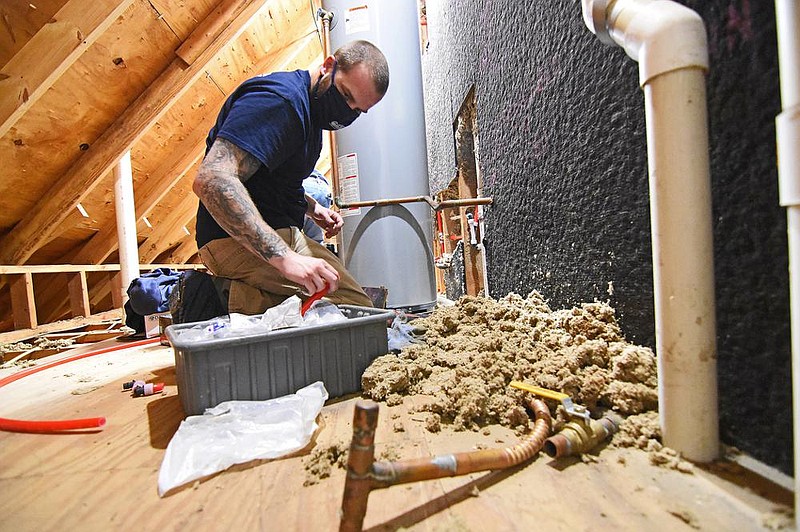 Zach Nails, a plumber for American Leak Detection, works Thursday, Jan. 21, 2021 on repiping the upstairs portion of a house near the Cabot city limit.
(Arkansas Democrat-Gazette/Staci Vandagriff)
