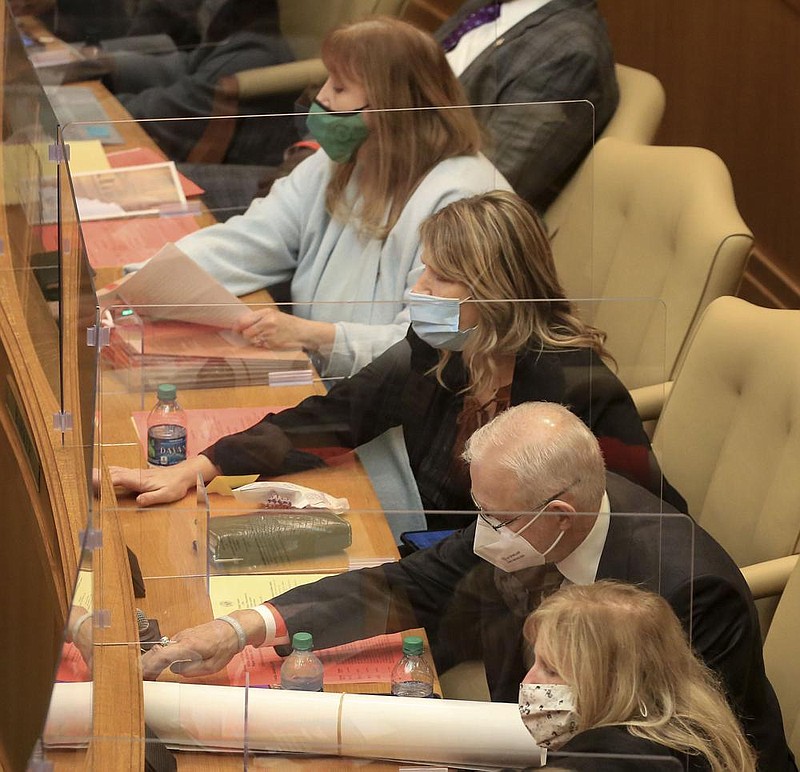 Representatives, from top, Frances Cavenaugh, R-Walnut Ridge, Sonia Eubanks Barker, R-Smackover, Joe Cloud, R-Russellville, and Gayla Hendren McKenzie, R-Gravette, vote on a bill Tuesday Jan. 26, 2021 in the Arkansas House at the state Capitol in Little Rock. More photos at arkansasonline.com/127leg/. (Arkansas Democrat-Gazette/Staton Breidenthal)