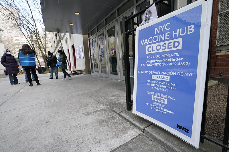 FILE - In this Jan. 21, 2021, file photo, people who had appointments to get COVID-19 vaccinations talk to New York City health care workers outside a closed vaccine hub in the Brooklyn borough of New York after they were told to come back in a week due to a shortage of vaccines. An increasing number of COVID-19 vaccination sites around the U.S. are canceling appointments because of vaccine shortages in a rollout so rife with confusion and unexplained bottlenecks. (AP Photo/Kathy Willens) story.lead_photo.caption