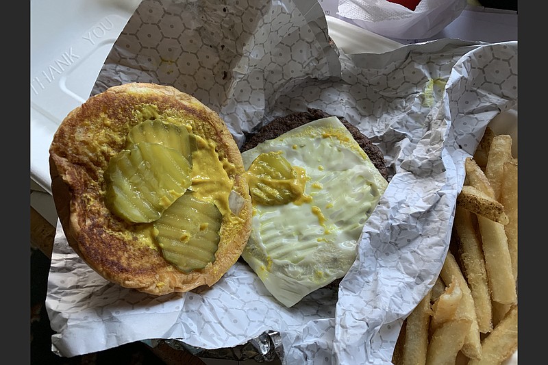 Our Minute Man burger, with processed Swiss cheese, mustard and pickles, produced pleasant memories, even if it maybe wasn’t worth a 30-minute wait in a bitingly cold wind. (Arkansas Democrat-Gazette/Eric E. Harrison)