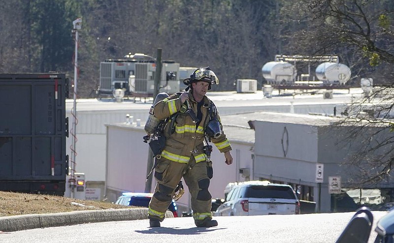 A Hall County firefighter leaves the area Thursday where a liquid nitrogen leak killed six people at Prime Pak Foods, a poultry plant in Gainesville, Ga. More photos at arkansasonline.com/129plantleak/.
(AP/John Bazemore)