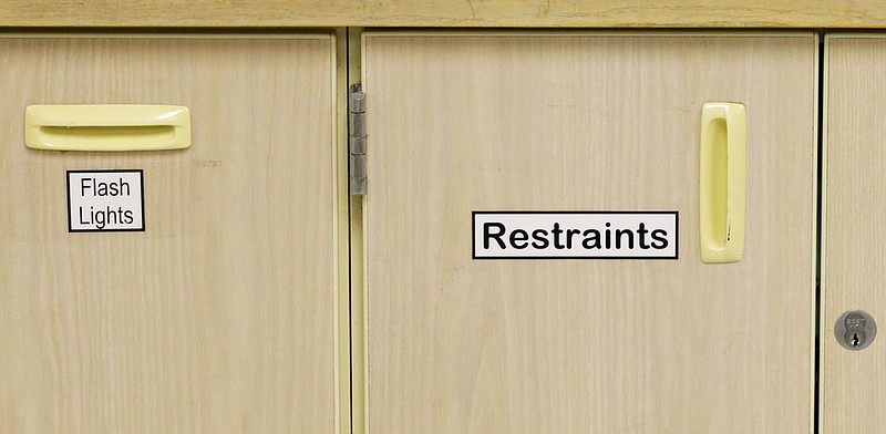 Labels on a cabinet in a ward at a psychiatric hospital in Lakewood, Wash., read "flashlights" and "restraints" in this Nov. 18, 2015, file photo.