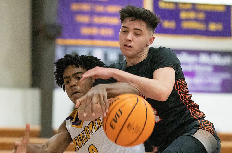 Mayflower’s Bj Gilliam (left) and Lamar’s Ethan Kendall (right) go for a loose ball Friday night at Mayflower gym. (Arkansas Democrat-Gazette/Justin Cunningham)