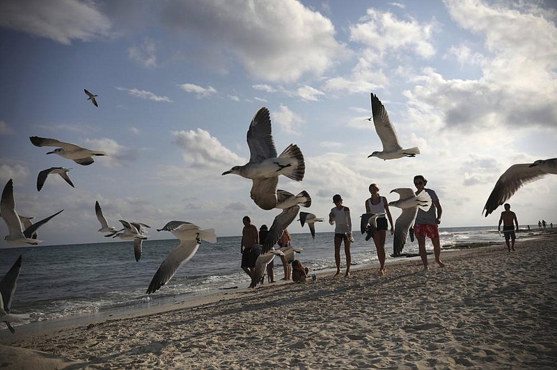 Tourists stroll on the shore of Xcalacoco beach in Playa del Carmen, Quintana Roo state, Mexico, in early January, amid the new coronavirus pandemic.
AP/Emilio Espejel)