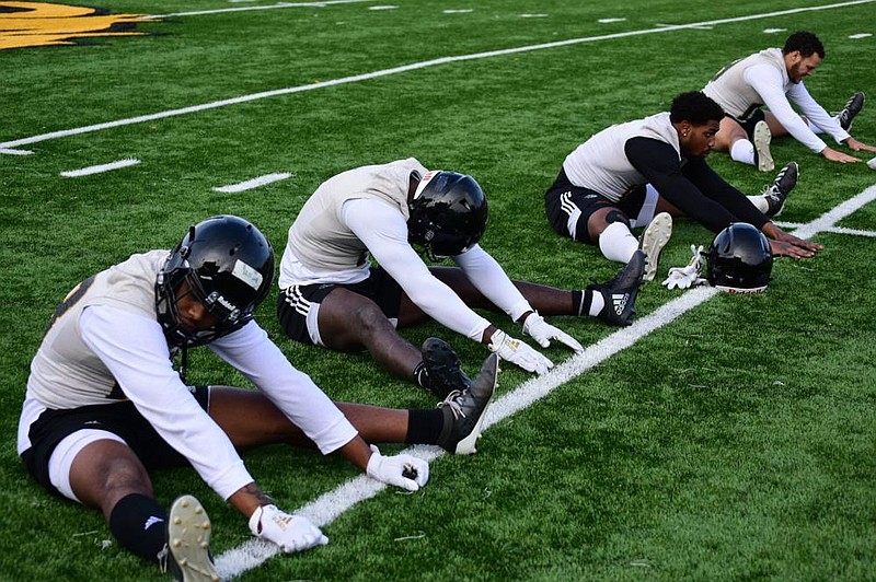 University of Arkansas at Pine Bluff receivers Dalyn Hill (from left), Harry Ballard III, Jeremy Brown and Darryl Carter warm up before the start of preseason camp Friday at Simmons Bank Field in Pine Bluff. 
(Pine Bluff Commercial/I.C. Murrell)