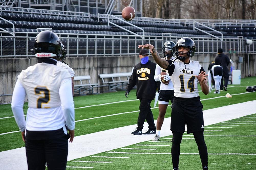 Joshua Hart and Donald Richardson of UAPB warm up their arms before the start of preseason camp Friday at Simmons Bank Field in Pine Bluff. Hart transferred from Arizona State, and Richardson is a newcomer from Arkansas State. 
(Pine Bluff Commercial/I.C. Murrell)